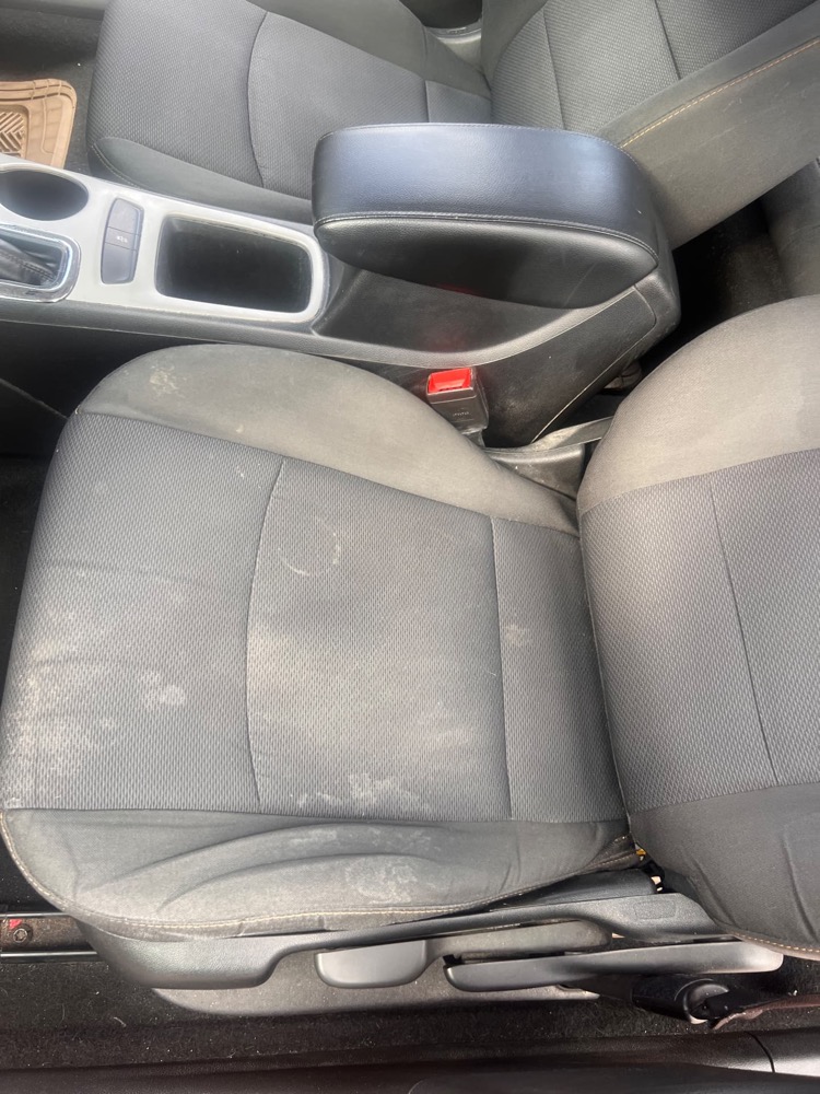Dirty and stained fabric car seat before interior cleaning in Kelowna
